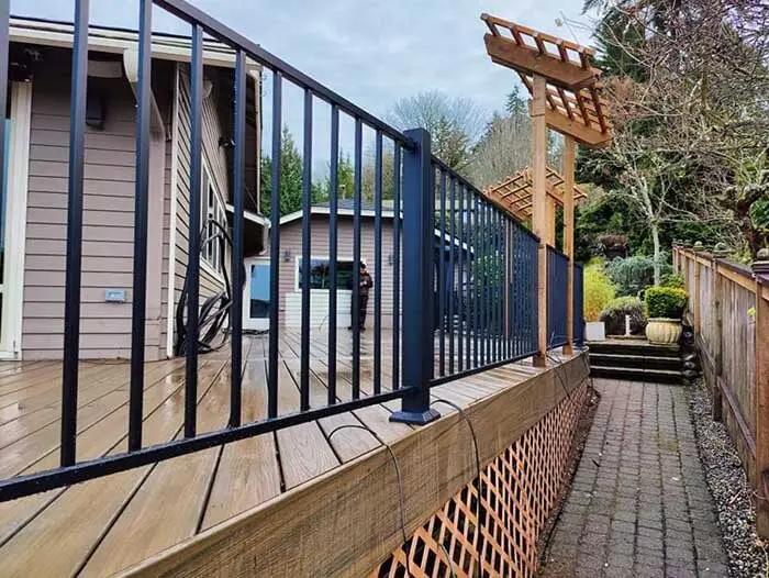Black aluminum picket deck railing viewed from the outside.