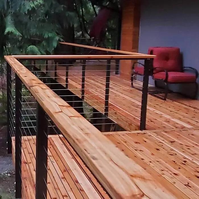 Natural cedar wood deck with steel cable railing combined with a natural wood top rail.